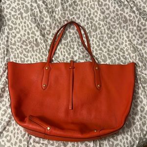 Orange large leather tote/purse! Used. Does have pen stain in bottom of bag!